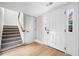 Inviting foyer with tiled stairs, hardwood floors, natural light, and convenient access to upper levels at 3 S Riversong Ln, Alpharetta, GA 30022