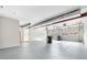 Spacious garage featuring three garage doors, concrete flooring, and painted walls at 3 S Riversong Ln, Alpharetta, GA 30022