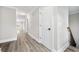 Bright hallway with vinyl plank floors, recessed lighting, and access to multiple rooms, creating a seamless flow at 3 S Riversong Ln, Alpharetta, GA 30022