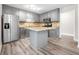 Modern kitchen features stainless steel appliances, gray cabinets, granite countertops, and hardwood floors at 3 S Riversong Ln, Alpharetta, GA 30022