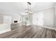 Spacious living room and dining area combination featuring fireplace, modern flooring, and natural light at 3 S Riversong Ln, Alpharetta, GA 30022