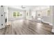 Spacious living room featuring a fireplace, large windows and modern gray vinyl floors at 3 S Riversong Ln, Alpharetta, GA 30022