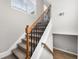 Carpeted staircase with decorative wrought iron railing and natural light, offers an appealing transition space at 3 S Riversong Ln, Alpharetta, GA 30022