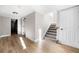 Hallway features tiled staircase with wooden railing, neutral paint, and access to other rooms in the house at 3 S Riversong Ln, Alpharetta, GA 30022