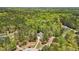 Expansive aerial view of a home surrounded by lush, mature trees with neighborhood homes afar at 45 Harvey Ave, Covington, GA 30016