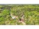 Expansive aerial view of a home surrounded by lush, mature trees with neighborhood homes afar at 45 Harvey Ave, Covington, GA 30016
