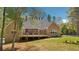 Charming brick home featuring a spacious wooden deck overlooking the serene backyard and lush greenery at 45 Harvey Ave, Covington, GA 30016