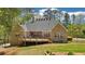 Charming brick home featuring a spacious wooden deck overlooking the serene backyard and lush greenery at 45 Harvey Ave, Covington, GA 30016