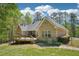 Charming brick home featuring a spacious wooden deck overlooking the serene backyard and lush greenery at 45 Harvey Ave, Covington, GA 30016