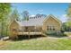 Charming brick home featuring a spacious wooden deck overlooking the serene backyard and lush greenery at 45 Harvey Ave, Covington, GA 30016