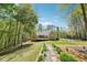 Beautifully landscaped backyard with a stone path leading to a charming outdoor area at 45 Harvey Ave, Covington, GA 30016