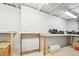 Unfinished basement workshop space, offering utility shelving and concrete walls for storage and projects at 45 Harvey Ave, Covington, GA 30016