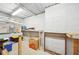 Functional unfinished basement workshop area, complete with utility shelving and concrete walls for organization at 45 Harvey Ave, Covington, GA 30016