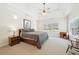 Cozy bedroom with a trey ceiling, neutral color scheme, carpet, and ample sunlight at 45 Harvey Ave, Covington, GA 30016