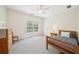 Bright bedroom with a bed, ceiling fan, and a large window offering abundant natural light at 45 Harvey Ave, Covington, GA 30016