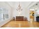 Bright dining room featuring hardwood floors, a modern chandelier, and a large window with natural light at 45 Harvey Ave, Covington, GA 30016