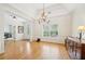 Bright dining room features a chandelier, large window, and hardwood floors at 45 Harvey Ave, Covington, GA 30016