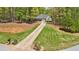 A beautiful home on a large lot with a long private driveway and surrounded by lush greenery at 45 Harvey Ave, Covington, GA 30016