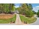 A beautiful home on a large lot with a long private driveway and surrounded by lush greenery at 45 Harvey Ave, Covington, GA 30016