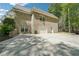 Brick home with a three-car garage and a long driveway, situated on a wooded lot, offering privacy and ample parking at 45 Harvey Ave, Covington, GA 30016