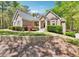Charming brick home featuring a well-manicured lawn and mature landscaping at 45 Harvey Ave, Covington, GA 30016