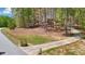 A beautifully landscaped front yard with mature trees and a long driveway at 45 Harvey Ave, Covington, GA 30016