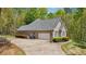Home's attached garage with ample parking space and a well-maintained landscaped exterior at 45 Harvey Ave, Covington, GA 30016