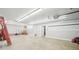 Spacious three-car garage with ample room for parking and storage, featuring bright overhead lighting at 45 Harvey Ave, Covington, GA 30016
