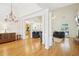 Open-concept living area with hardwood floors, decorative columns, and abundant natural light, perfect for entertaining at 45 Harvey Ave, Covington, GA 30016