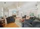 Large living room with multiple sofas, stone fireplace, and hardwood flooring at 45 Harvey Ave, Covington, GA 30016