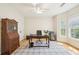 Comfortable office space with a ceiling fan, hardwood floors, natural light, and storage at 45 Harvey Ave, Covington, GA 30016