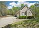 View of the home's side exterior, showing the attached garage, driveway, and partial landscaping at 45 Harvey Ave, Covington, GA 30016