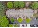 Aerial view of townhomes with gray roofs and green trees at 4880 Payson Se Ter, Atlanta, GA 30339