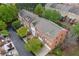Aerial shot of brick townhomes with dark-gray roofs and well-maintained landscaping at 4880 Payson Se Ter, Atlanta, GA 30339