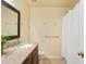 Bathroom featuring a double sink vanity, marble countertop, and shower with curtain at 4880 Payson Se Ter, Atlanta, GA 30339