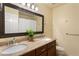 Bathroom with a double sink vanity, marble countertop, and large framed mirror at 4880 Payson Se Ter, Atlanta, GA 30339