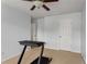 Bedroom featuring a treadmill, ceiling fan, and two doors at 4880 Payson Se Ter, Atlanta, GA 30339