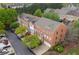 Aerial view of stately red brick townhomes boasting attached garages and manicured landscaping at 4880 Payson Se Ter, Atlanta, GA 30339