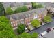 Aerial view of townhomes with brick facades, well-maintained yards, and attached garages at 4880 Payson Se Ter, Atlanta, GA 30339