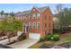 Beautiful brick townhome with lush landscaping, attached garage and an inviting front entrance with stairs at 4880 Payson Se Ter, Atlanta, GA 30339