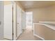 Hallway with neutral color palette, bright lighting, and multiple doors leading to rooms at 4880 Payson Se Ter, Atlanta, GA 30339