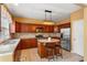 Spacious kitchen with stainless steel appliances, dark wood cabinets, kitchen island, and tile floors at 4880 Payson Se Ter, Atlanta, GA 30339