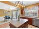 Open concept kitchen with stainless appliances, dark wood cabinets, island, and eat-in dining area at 4880 Payson Se Ter, Atlanta, GA 30339
