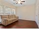 Bright living room featuring a comfortable couch, hardwood floors, and a ceiling fan at 4880 Payson Se Ter, Atlanta, GA 30339