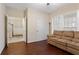 Open living room with hardwood floors and a beige couch at 4880 Payson Se Ter, Atlanta, GA 30339