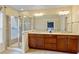 Spacious main bathroom with double sinks, a large mirror, vanity, and a glass-enclosed shower at 4880 Payson Se Ter, Atlanta, GA 30339