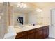 Main bathroom featuring a dual sink vanity, spacious countertop, and views into the main bedroom at 4880 Payson Se Ter, Atlanta, GA 30339