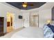 Cozy main bedroom with ample natural light, a ceiling fan, and access to the ensuite bathroom at 4880 Payson Se Ter, Atlanta, GA 30339