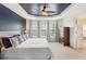 Well-lit main bedroom featuring neutral carpet, stylish curtains, and an attached bathroom with a shower at 4880 Payson Se Ter, Atlanta, GA 30339