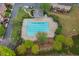 Aerial view of community pool area with ample space, surrounding greenery, and nearby parking at 4880 Payson Se Ter, Atlanta, GA 30339
